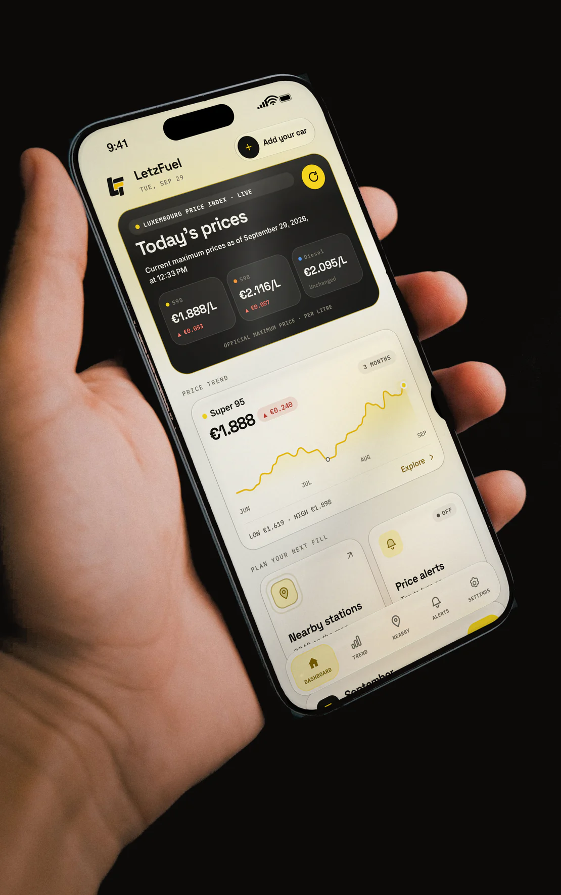 LetzFuel's dashboard, with today's official fuel prices, on an iPhone held in a hand
