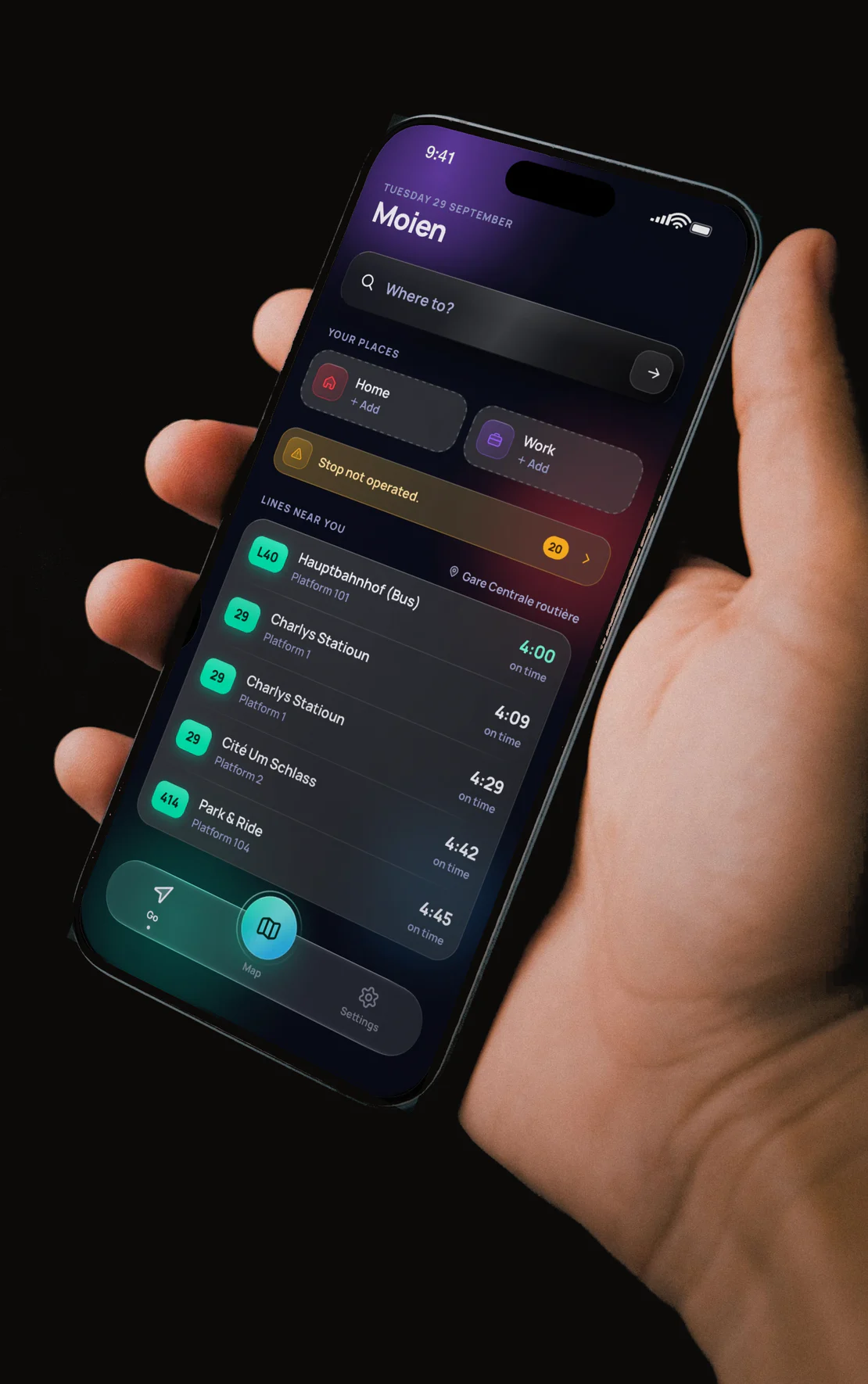 MobiLux's home screen, with lines near you and live departures, on a phone held in a hand